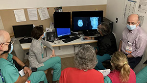 people gathered around looking at a computer screen