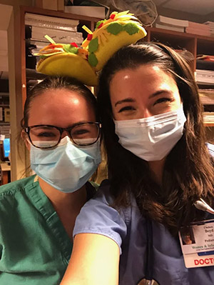 two people wearing PPE and posing for a photo