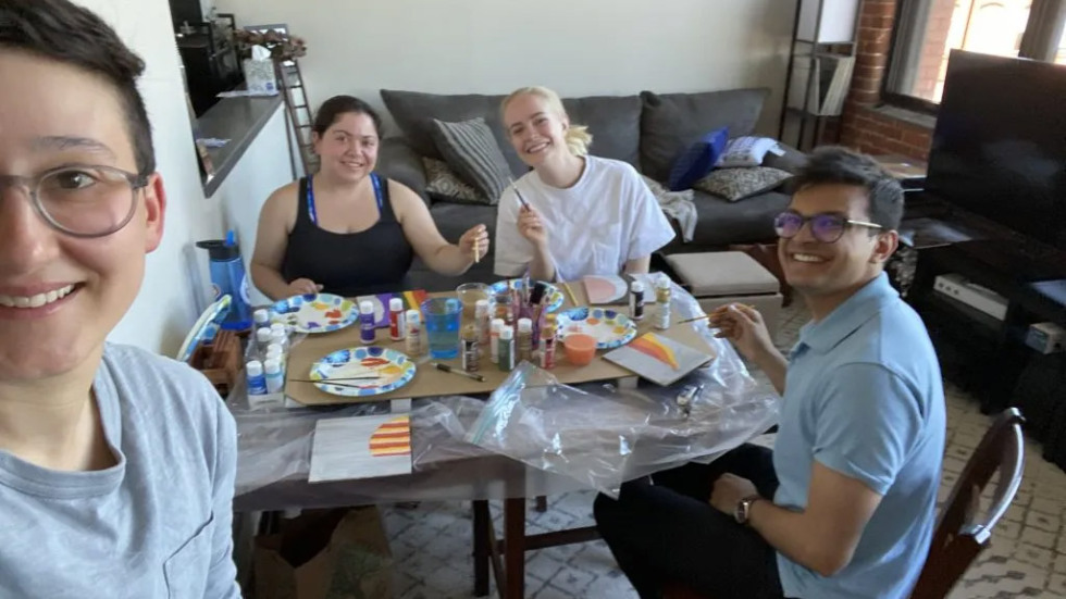 people at a table working on arts and crafts