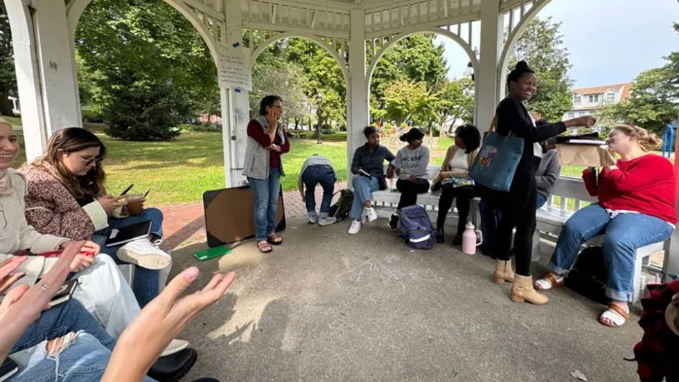 several people sitting together in a gazebo