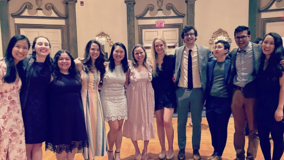 several people in fancy attire posing for a photo